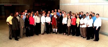 large group photo taken with a Ben Franklin figure