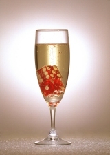 photo of a glass of champagne with dice in it